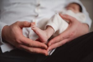 Photo of a 14-day-old baby being held by her father.