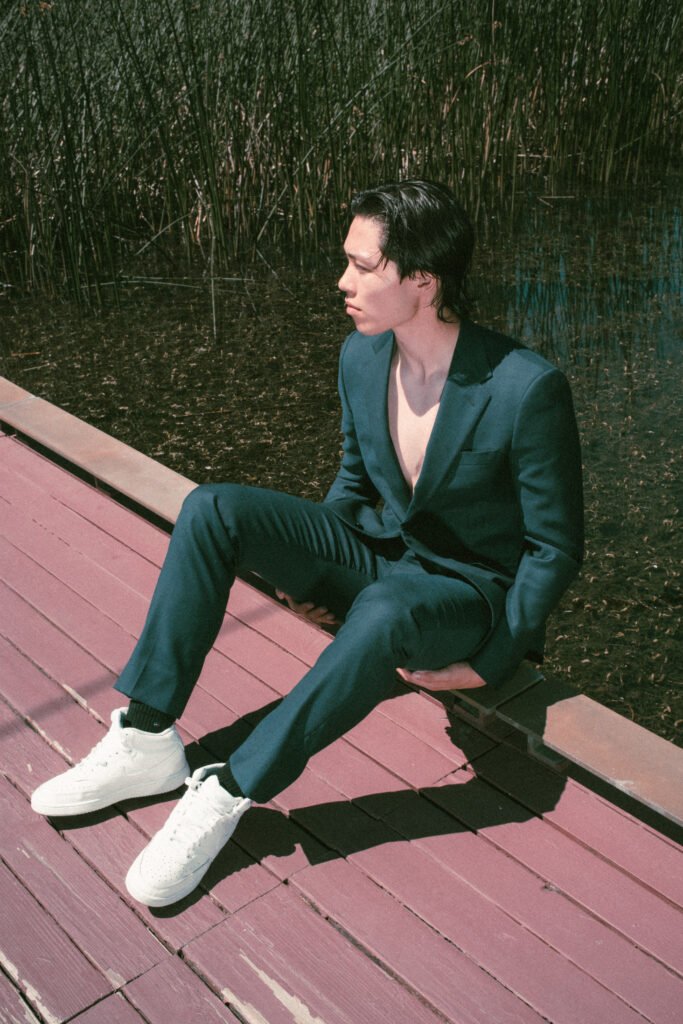 High-end fashion editorial showcasing modern menswear with a male model in a blue suit at the Richmond Olympic Oval.