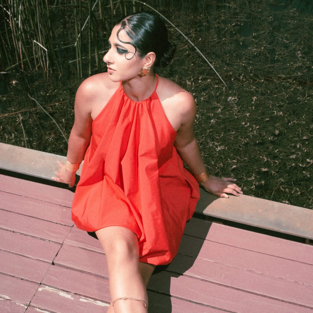 High-end fashion editorial photo of Mya, an Emirates hostess, wearing a short red dress by Zara at the Richmond Oval.